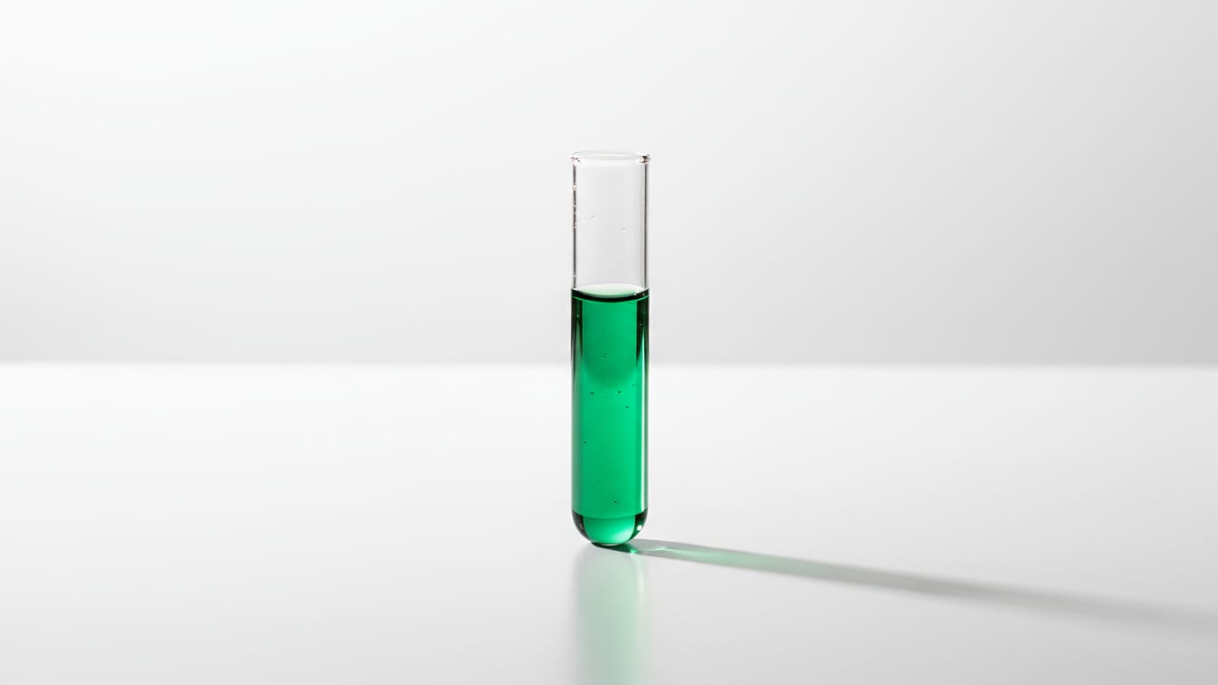 Illustration: A clear microcentrifuge tube with liquid on a white lab bench, with green and copper reflections.